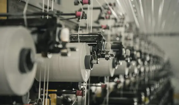 A row of garment making machines that are placed next to each other.