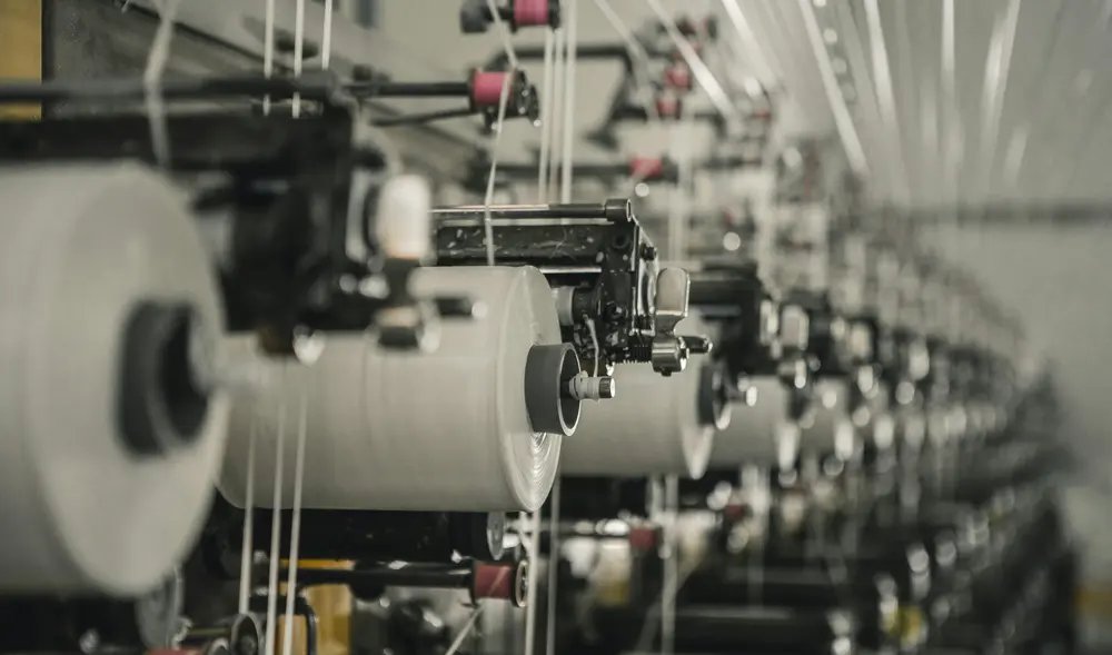 A row of garment making machines that are placed next to each other.